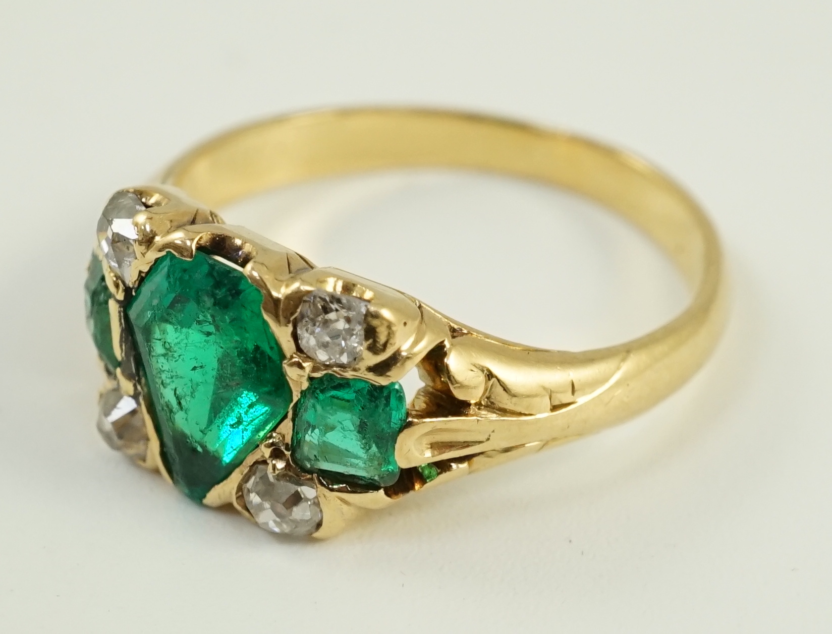 A gold, emerald and diamond cluster ring